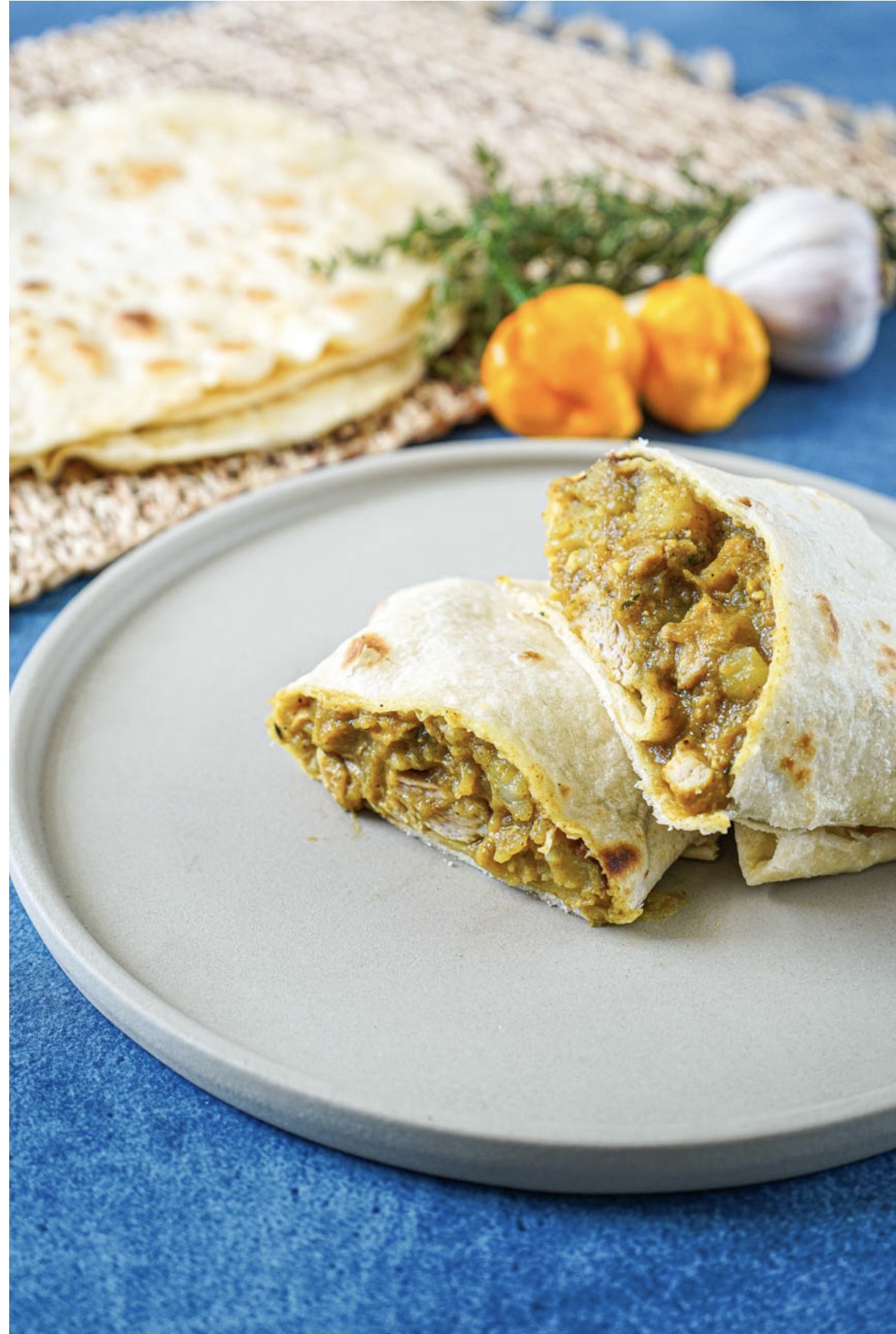 Freshly made Caribbean roti with curried filling, roti skins, scotch bonnet peppers and thyme